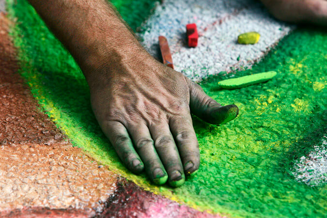 A chalk artist works on his artwork during the inaugural Chalk Art Festival at the Indian River Mall parking lot.