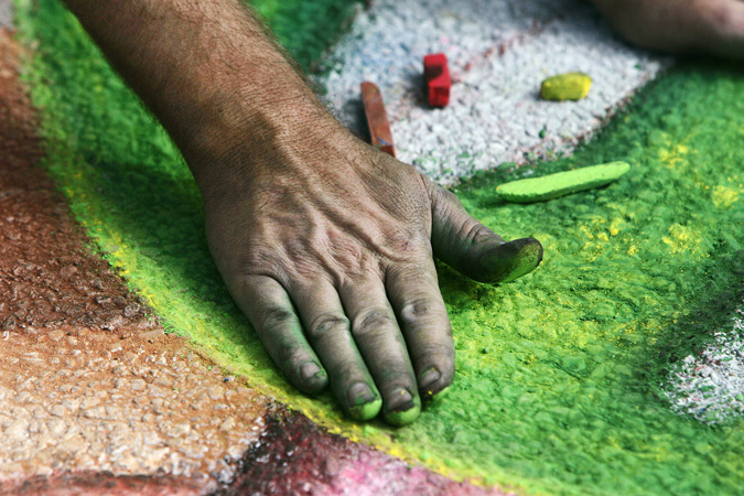 A Chalk artist works on his artwork during the 1st annual Chalk Art Festival at the Indian River Mall parking lot. (staff photo : Tim Hunt)