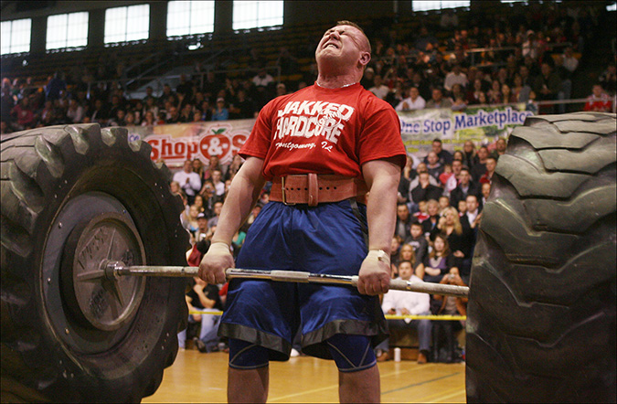 Karl Gillighan tries to lift a 800 pound tire barbell in a strongman show hosted  by the Hammond Civic Center, Sunday, April 17, 2011.