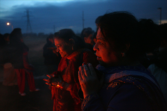 Hindu women pray near the holika dahan during the Hindu celebration of Holi at the Indian American Cultural Center in Merrillville, Sunday, March 20, 2011.