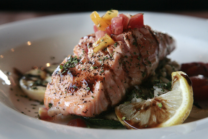 Seared salmon with grilled vegetables and balsamic glaze.